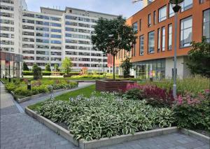 a garden in the middle of a city with buildings at Amazing view-18th floor-2 bedrooms flat - free parking in Trnávka