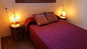 a bedroom with a bed with two lamps on it at Casas Rurales Los Molinos in Sanlúcar de Guadiana