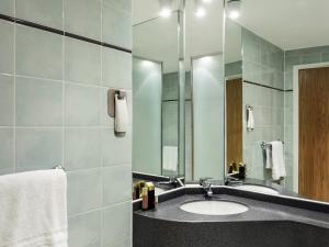a bathroom with a sink and a mirror at ibis Hotel Northampton Centre in Northampton +51 photos