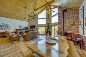 a living room with a table and a brick wall at Mtn-View Deck at Home 7 Mi to Tonto Natural Bridge in Pine