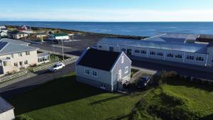 an aerial view of a building with the ocean in the background at Holiday Home in town Eyrarbakki South of Iceland - Birta Rentals in Eyrarbakki