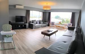 a living room with a couch and a table at Hillside Heaven quiet and comfortable in Rotorua