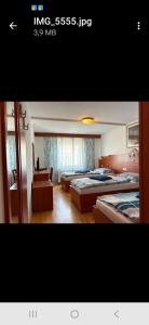 a hotel room with two beds and a couch at Motel Mijošek in Rogaška Slatina