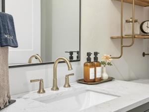 a bathroom with a white sink and a mirror at Baby Birch Banks Guest House on Lake Pend Oreille in Sagle +39 photos
