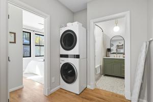 a washer and dryer in a room with a mirror at Baby Birch Banks Guest House on Lake Pend Oreille in Sagle