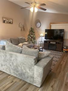 a living room with a couch and a christmas tree at Dear Love Cabin in Ruidoso