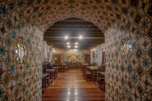 an archway in a restaurant with tables and chairs at Hacienda Cusin in Otavalo