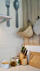 a kitchen counter with utensils and a basket on the wall at La Casa de Praves in Praves
