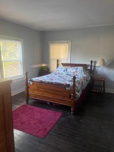 a bedroom with a bed with a wooden frame at Private Cottage in Rural Clemmons in Clemmons