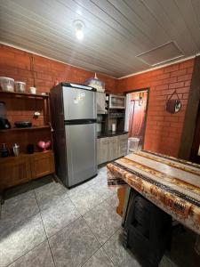 una cucina con un frigorifero in acciaio inossidabile in una stanza di FLAT - ALUGO POR DIAS - Sua casa de praia te espera! a Balneário Barra do Sul