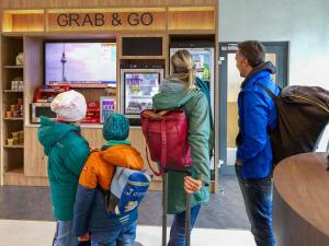 a group of people standing in front of a grab and go store at Novotel Suites Berlin City Potsdamer Platz in Berlin +72 photos