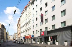 a tall white building on a city street at ibis Wien City in Vienna