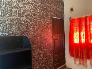 a room with a red door and a red curtain at Bonita habitación a 3 min Del Word Trade Center in Veracruz