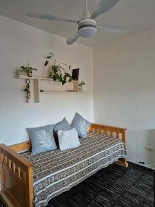 a bedroom with a bed with blue pillows on it at Aire Serrano - Departamento San Luis in San Luis