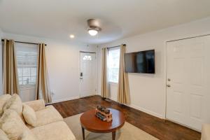 a living room with a couch and a table at Updated North Greenwood Cottage Less Than 1 Mi to Dtwn! in Greenwood