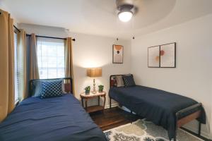 a bedroom with two beds and a window at Updated North Greenwood Cottage Less Than 1 Mi to Dtwn! in Greenwood