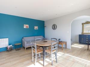 a living room with a table and a couch at Gîte de Charme : Calme, Nature, Proche du Mans, Terrasse, Jardin, Parking Privé - FR-1-410-397 in Montbizot +9 photos