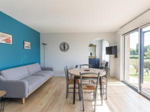 a living room with a couch and a table at Gîte de Charme : Calme, Nature, Proche du Mans, Terrasse, Jardin, Parking Privé - FR-1-410-397 in Montbizot