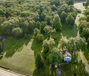 a house in the middle of a field with trees at PA Country 1870 Colonial on 5 Acres in Greenville