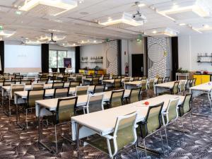 a classroom with tables and chairs in a room at Novotel Paris Centre Gare Montparnasse in Paris