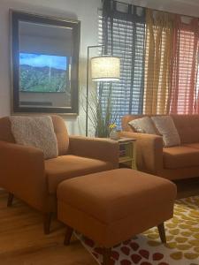 a living room with two couches and a flat screen tv at Entire Vacation home blocks to the Strip, ARTS Dist, & Main Street Sleeps up to 8 in Las Vegas