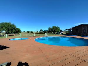a patio with a pool and a wooden deck at Casas para 6 personas in Juan L. Lacaze