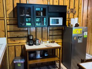 a kitchen with a counter and a refrigerator at Eco Finca Tucan in Monteverde Costa Rica