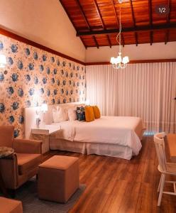 Ένα ή περισσότερα κρεβάτια σε δωμάτιο στο Vale dos Pássaros - Pousada e SPA Suíte 4 Luxo