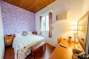 Voodi või voodid majutusasutuse Palm Tree Hotel Kenting toas