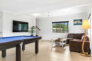 a living room with a pool table and a couch at Coastal Bliss - 3 Beds Holiday House in Burrum Heads