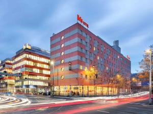 a tall building with a hotel on top of it at Ibis Praha Mala Strana in Prague