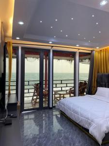 una camera da letto con un letto e vista sull'oceano di Shapes Beach House a Kokrobite