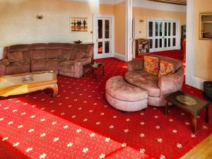 a living room with a couch and two couches at Riviera Mansion, Torquay in Torquay