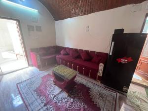 an overhead view of a living room with a red couch at Hamd Nubian Guest House in Aswan