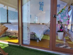 a room with a bed through a glass door at Mistica Titicaca Perú lodge in Puno
