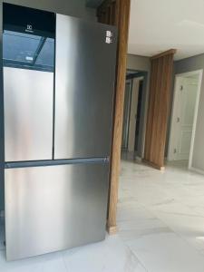 a stainless steel refrigerator in the middle of a kitchen at Apartamento em Governador Celso Ramos in Governador Celso Ramos