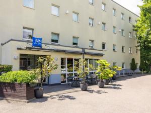 a large building with plants in front of it at ibis budget Basel Pratteln in Pratteln