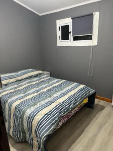 a bed in a bedroom with a window at La MERCED 