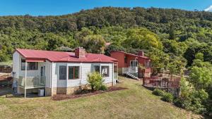a house with a red roof on top of a yard at Bimbadeen Estate Villa 3 in Mount View