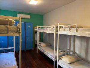 a room with three bunk beds in a room at Hostel Casa 8 in Rio de Janeiro