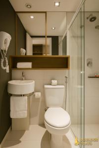 a bathroom with a toilet and a sink at Luxo e Comodidade Sentin Sao Luiz in Sao Paulo