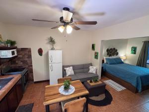 a living room with a couch and a bed and a table at Tiny Paradise Ground Floor Studio in Coco
