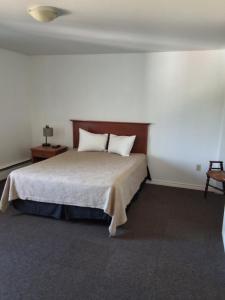 a bedroom with a bed with two pillows on it at Wildwood Hotel in Wildwood +3 photos