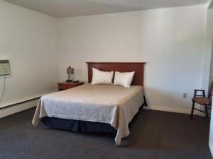 a bedroom with a bed and a table and a chair at Wildwood Hotel in Wildwood