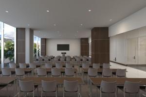 a conference room with tables and chairs and a screen at AC Hotel by Marriott Beverly Hills in Los Angeles