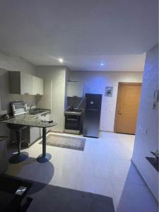 a kitchen with a table and a stove in it at Apartment residence tamanalt hay al salam agadir in Agadir