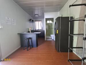 a kitchen with a black refrigerator in a room at Apartamentos Modular Bahía Ballena in Bahia