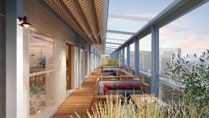 a balcony with benches and tables on a building at The Waymark Chattanooga, Tapestry Collection By Hilton in Chattanooga