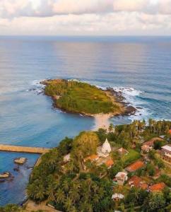an aerial view of an island in the ocean at Newton House in Hiriketiya +38 photos