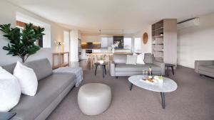 a living room with a couch and a table at Surf N Turf in Kiama